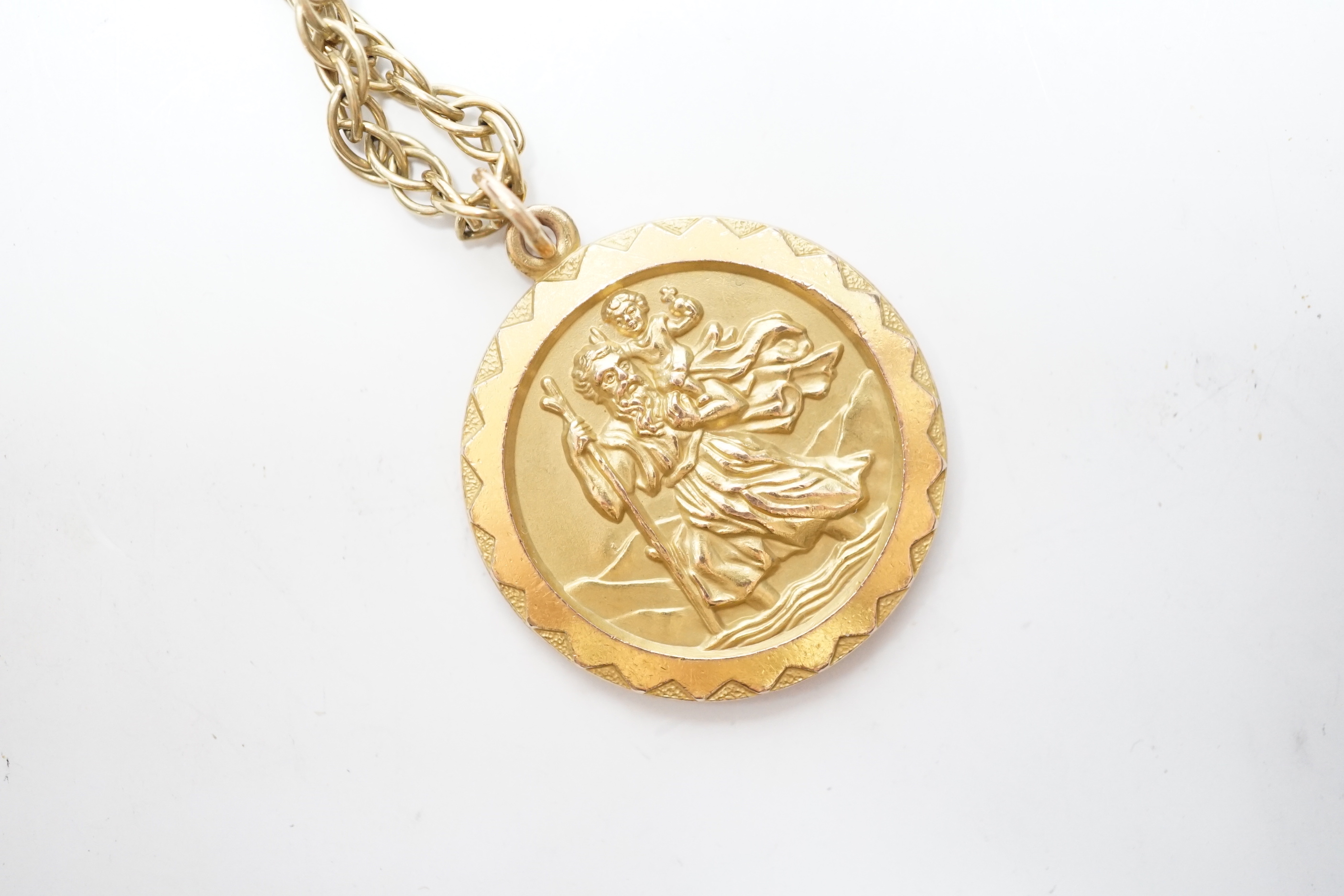 A 1970's 9ct gold St. Christopher's pendant, 27mm, on a 9ct chain, 65cm, 22.6 grams.